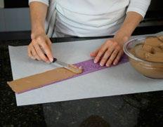 Then line up the short end with the acetate cake wrap and gently un-roll flush with the edge,
