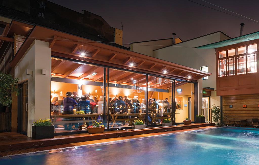 On warmer evenings the doors slide back opening directly onto the pool.