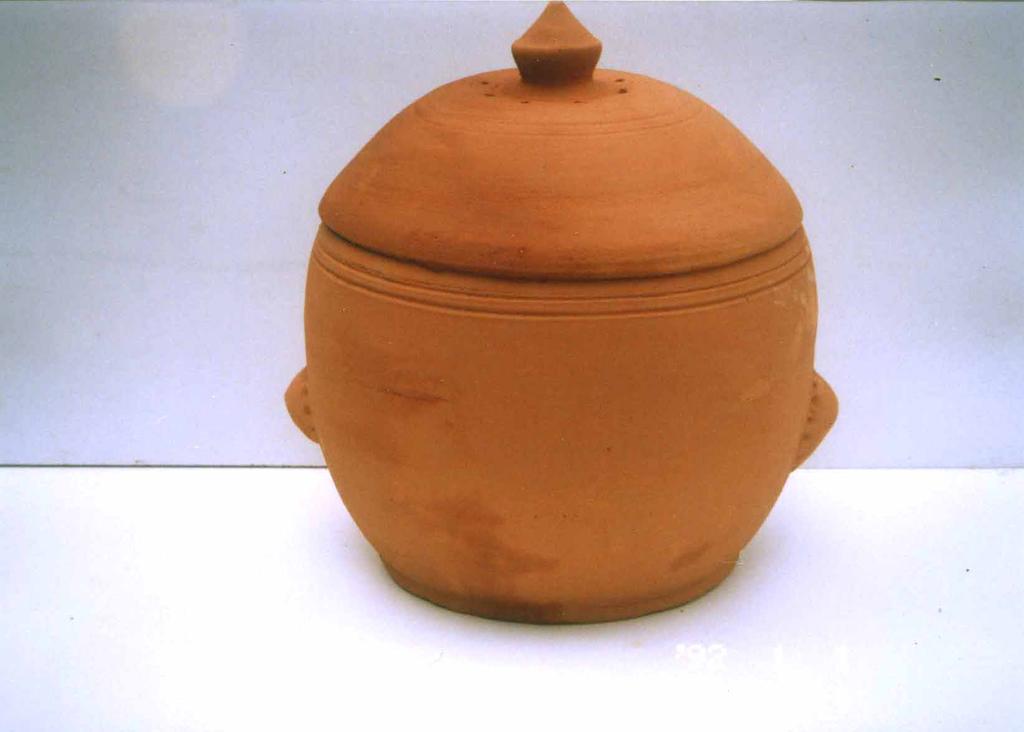 Design No. 2 Content : Terracotta Pot of 285mm X 27mm X 35mm Terracotta Lid of 35mm X 12mm (Fig No. 2) Specification : Sheetal Pot has an extra round rim at the top which has to be filled with water.