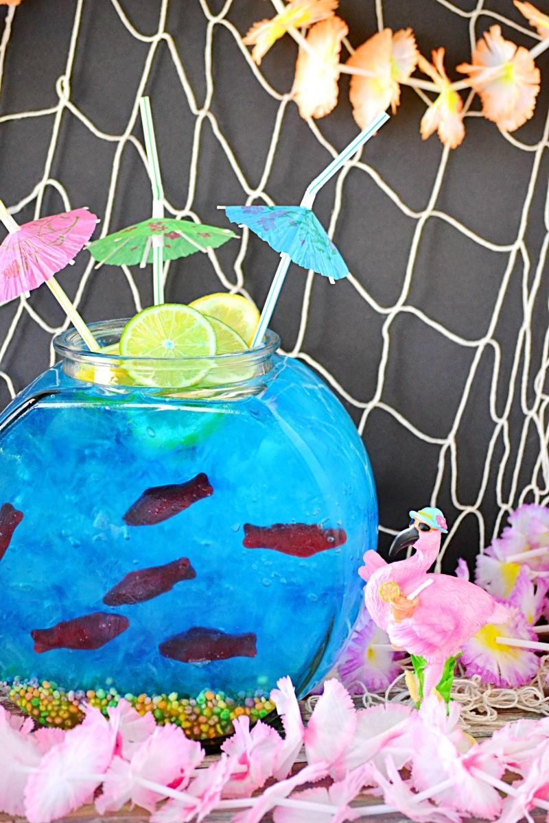 FISH BOWL PUNCH 1 gallon glass fish bowl 2 (5 ounce) boxes nerds candy 1 (2 liter) 7up or any CLEAR soda blue gel food coloring ice (5 to 8 pounds) 1 bag red Swedish fish gummy candy fun straws