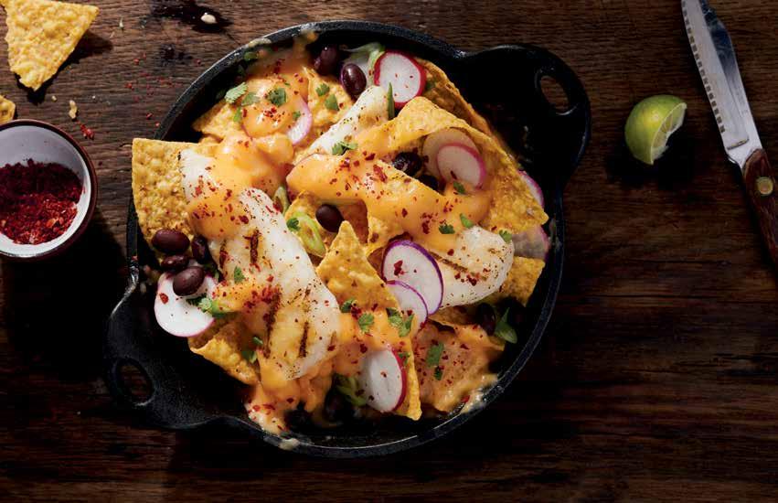 KOREAN NACHOS GRILLED WILD & KIMCHI CHEESE SAUCE Nachos go fusion with this spicy combination of corn chips topped with