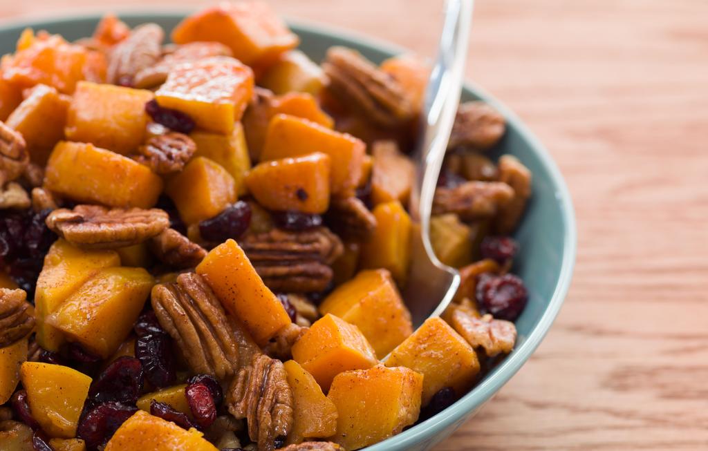 Roasted Butternut Squash with Pecans & Cranberries 2 tablespoons olive oil, divided 11/2 pounds of butternut squash, peeled, seeded and cut into 1" cubes (about 4 cups) 3 tablespoons pure maple syrup
