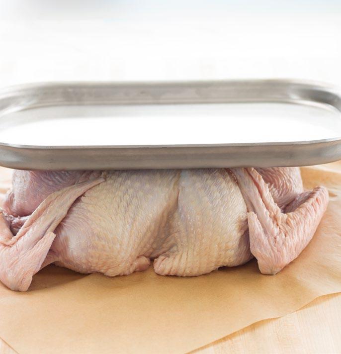 Flatten the turkey Pull the thighs outward so the turkey lies flat, with the wings facing inward. Tuck the wing tips under to secure. Brush with oil and roast Preheat oven to 450ºF.