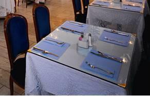 Begin with the Linen The cloth should extend evenly on each side of the table.
