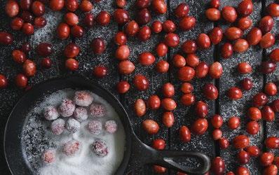 How to assemble the Candied Rosemary and Sugared Cranberries: Carefully place the cranberries into the syrup and with a slotted spoon, stir the cranberries and ensure that all sides are coated.