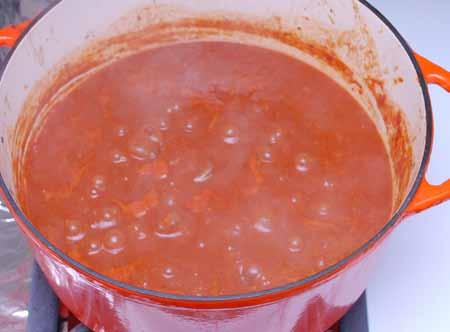 13 8 Add the tomatoes with their juice or purée, the beef broth, chopped garlic, and