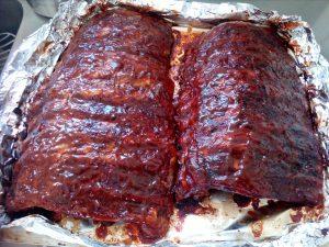 Divide the sauce in to 2 containers and from 1 container using a pastry brush cover the ribs with the sauce covering all exposed areas. Cover pan tightly with heavy-duty foil.