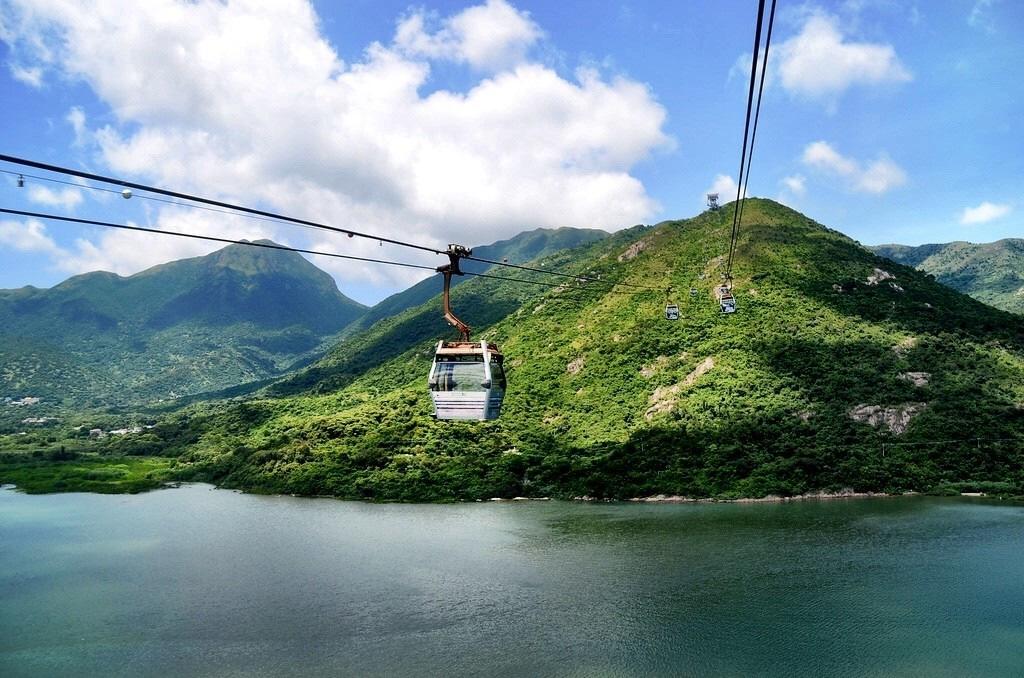 minutes cable car ride with breathtaking panorama of the Hong Kong International Airport, verdant, mountainous terrain