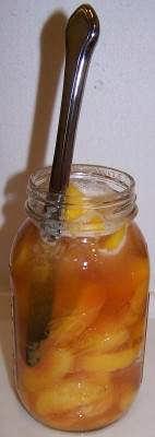 Run a rubber spatula or table knife gently between peaches and jar to release trapped air bubbles.