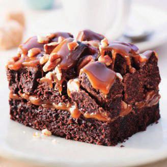 Rockslide Brownie A light textured Brownie topped with butter-luscious caramel, piled high with Brownie cubes, toasted pecans and drizzle with milk chocolate ganache.