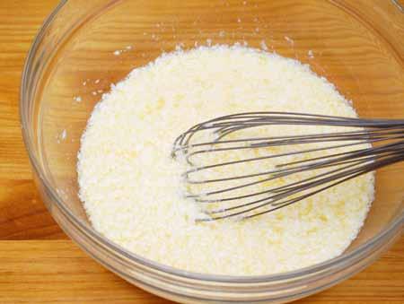 4 4 Add the room-temperature butter and break it up into small beads with the whisk.