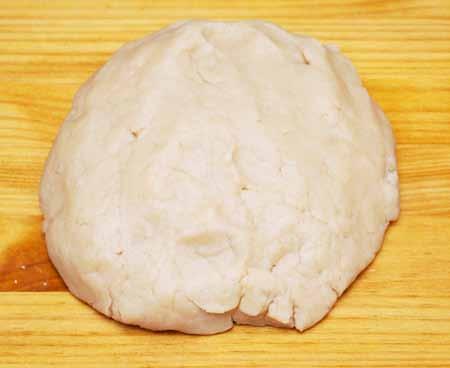 6 5 Combine the dough ingredients until the mixture is dry enough to knead with your hands. Transfer the mixture to a clean surface and begin squeezing the dough together and kneading it until smooth.