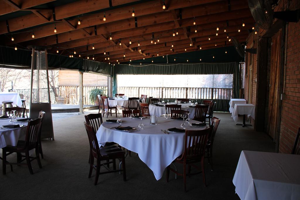 is our covered outdoor dining patio, complete with an open air deck, and overlooks the historic Marine Creek River Wfalk and Chef Love s private garden.