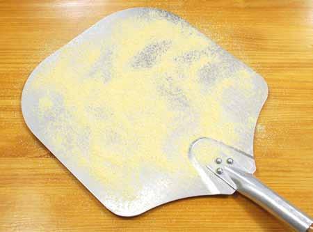 Cover the shaped pizza dough with plastic wrap and let rise 30 to 45 minutes. 11 When working with a pizza peel, dust the peel well with corn meal before placing the dough on it.