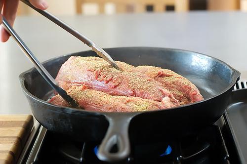 When the oil is to the smoking point, place the tenderloin in the very hot pan to sear it.