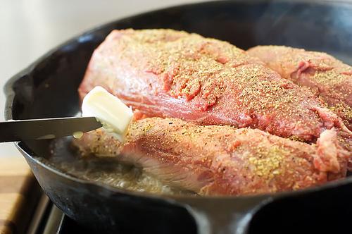 After I put the meat into the pan, I throw a couple of tablespoons of butter into the skillet, to give