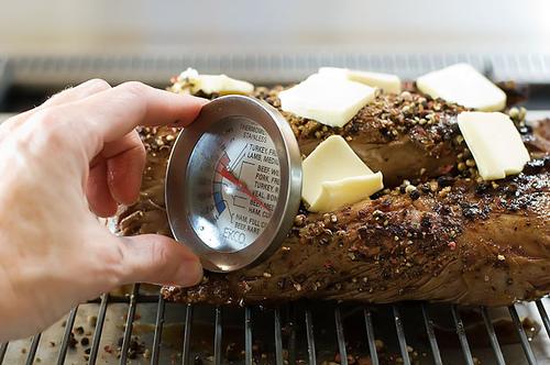 Stick the long needle of the thermometer lengthwise into the meat, so it will get a representative read of the internal temperature.