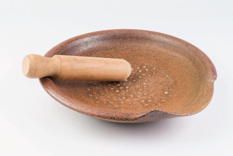 MORTAR AND PESTLE INFORMATION This flat dish is a mortarium and the wooden tool is a pestle.