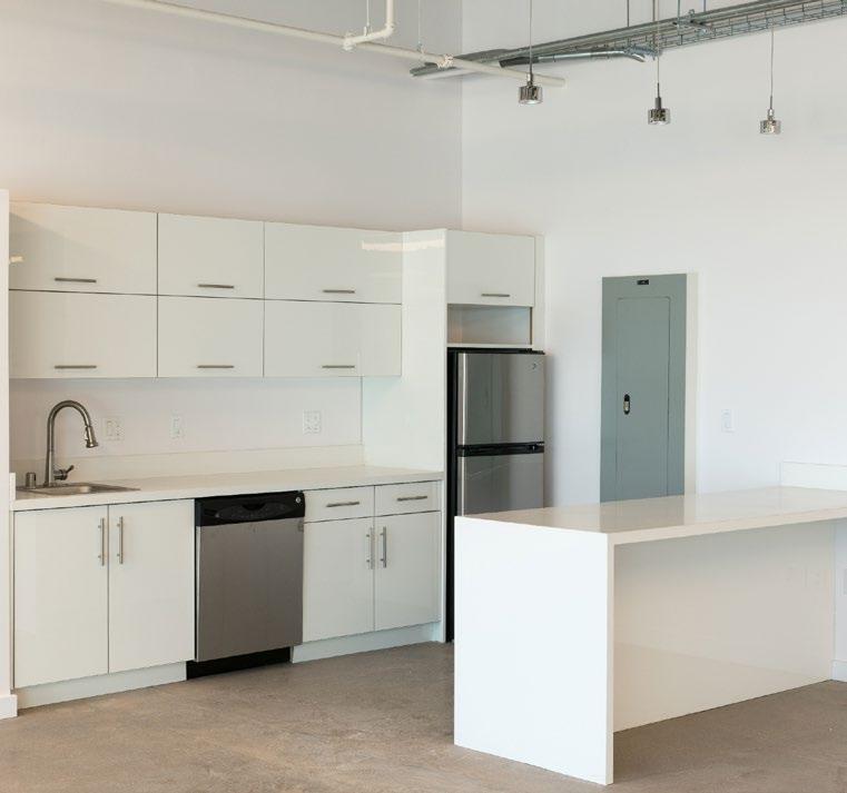 The building offers move-in ready spaces, with kitchenettes, exposed ceilings, polished concrete floors, glass offices, and large perimeter windows for abundant natural light.