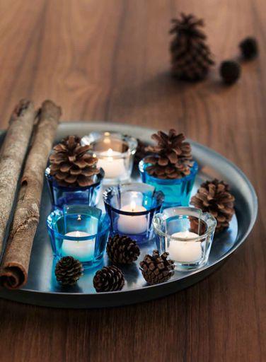 97 Arrange votives on a tray and decorate with cones and