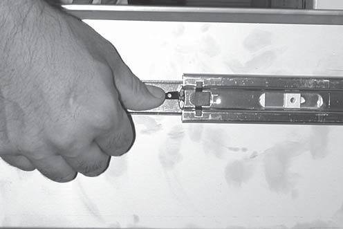 To remove the drawer; pull it completely out. Release the drawer from the drawer slides by pressing the black lever down on the right side, and up on the left side.