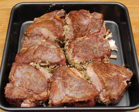 12 Arrange the stuffed chops in a baking pan. I put the stems from the mushrooms in the bottom of the pan first.