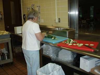 More Volunteers! Volunteers sliced 140 lbs. Of fresh zucchini to be frozen, and shredded over 30 lbs.
