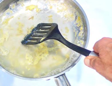 12. Lift the cooked scrambled eggs out of