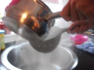 Pour pasta and water into a colander over the