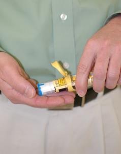 4. Tip each carrier tube and verify that each auto-injector readily slides out of the tube. Visually inspect both auto-injectors to confirm each label is fully adhered to the auto-injector.