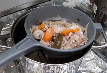 ) I carefully pour all the contents of the pressure cooker into the strainer and in about a minute or two all the stock