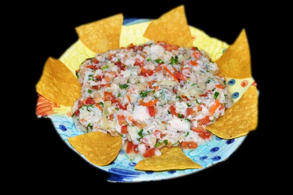 GUACAMOLE DIP CEVICHE* $12.95 NACHOS Crispy corn tortilla chips topped with refried beans, cheese, sour cream, guacamole, jalapeños and tomatoes. 10.