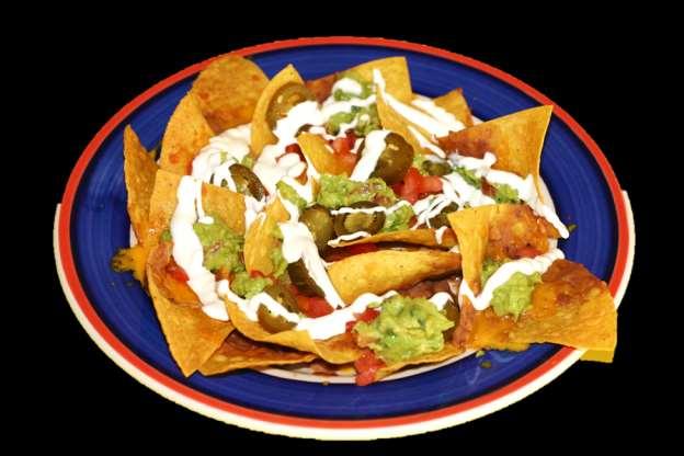 25 TACO SALAD A large tortilla shell filled with chicken or beef, topped with lettuce tomatoes, sour cream and guacamole. Naked taco salad now available 9.