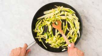 In the meantime, press or finely chop the garlic. 2 FRY THE COURGETTI 5 minutes before the linguine is done, heat the butter in a wok to medium-high heat, add the garlic and fry for 1 minute.