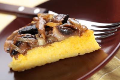 Polenta with Mushrooms Serves: 4 250g Polenta 400g Mushrooms. sliced 175g Gruyere Cheese, grated 50g Butter Salt & Pepper to own taste 1. Line a shallow baking tin with baking paper. 2. Bring 1 ltr of water to a boil in a pan, add polenta in a steady stream, stirring constantly.