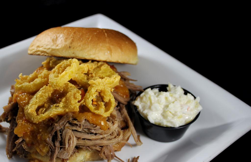 Mango Habanero Slow Cooked Pulled Pork The Rock s slow cooked pulled pork topped with our signature fried banana peppers, house made mango habanero sauce on a brioche bun and side of cole slaw.