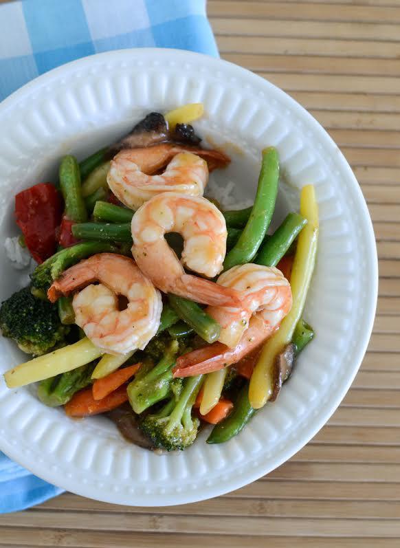 Quick and Easy Shrimp Stir Fry: 1 1/2 pound raw frozen shrimp, thawed 2 tablespoons butter 1 teaspoon garlic Serve With 4-6 cups frozen stir-fry vegetables Hot cooked rice for serving (about 2 cups