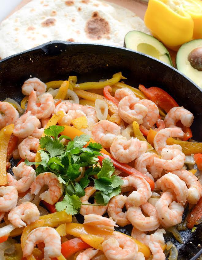 shrimp fajitas: 1 pound raw frozen shrimp, thawed 2 tablespoons butter or olive oil 1 teaspoon garlic (the minced kind in the jar) 1-2 tablespoons olive oil 1 red bell pepper, cut into strips 1