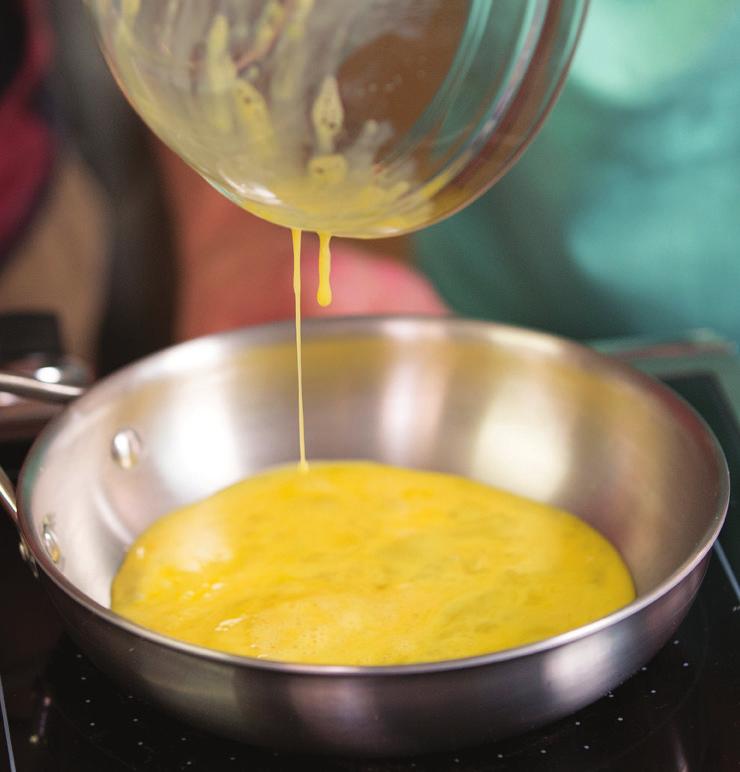 How to Scramble Your child can help pour the whisked eggs into the skillet, scramble them, and