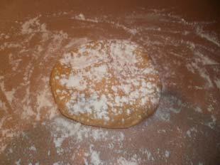 Press the bigger part of the dough into