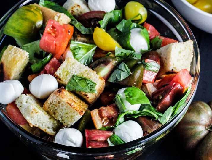 Heirloom Tomato Panzanella Salad 6 cups of New Leaf s Own Garlic Bread cut into 1 cubes 6 cups of Heirloom tomatoes, cut in large chunks 1/2 cup extra virgin olive oil 1/2 bunch basil leaves, torn 8