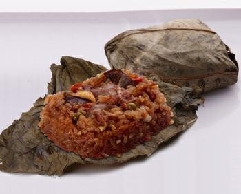 the ball of rice is then wrapped in a dried lotus leaf and steamed. In North America, banana, lily, or grape leaves may be used instead.in Malaysia and Singapore, there are two variants of lo mai gai.