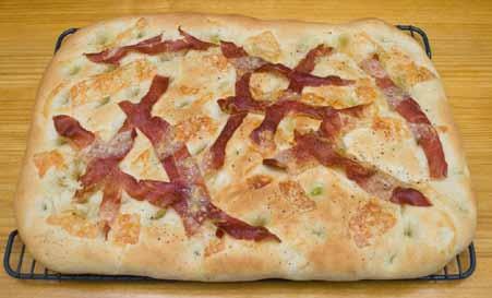16 Here is the finished prosciutto and Gruyère focaccia, fresh from the oven. This flat bread was delicious. We cut each focaccia in half and placed half of each on the table.