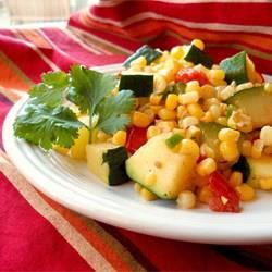 Calabacitas Servings: 6 2 1/2 cups fresh or frozen corn kernels (thawed) 1 tablespoon olive oil or avocado oil 1/4 cup chopped onion 1 clove garlic, minced 1 pound zucchini, sliced 3 Roma tomatoes,