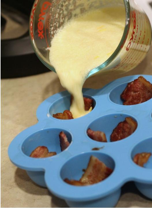 Pour some of the egg mixture from the large bowl into a pour-able Pyrex measuring bowl and add in cheese, pay attention the cheese clumping as you are pouring from the measuring bowl.