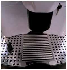 Open the machine door. 7 Clean the group from any coffee residues.