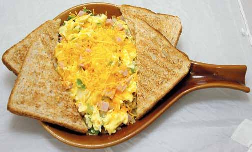 Served on a bed of golden hash browns, topped with Cheddar cheese and your choice of toast. 7.