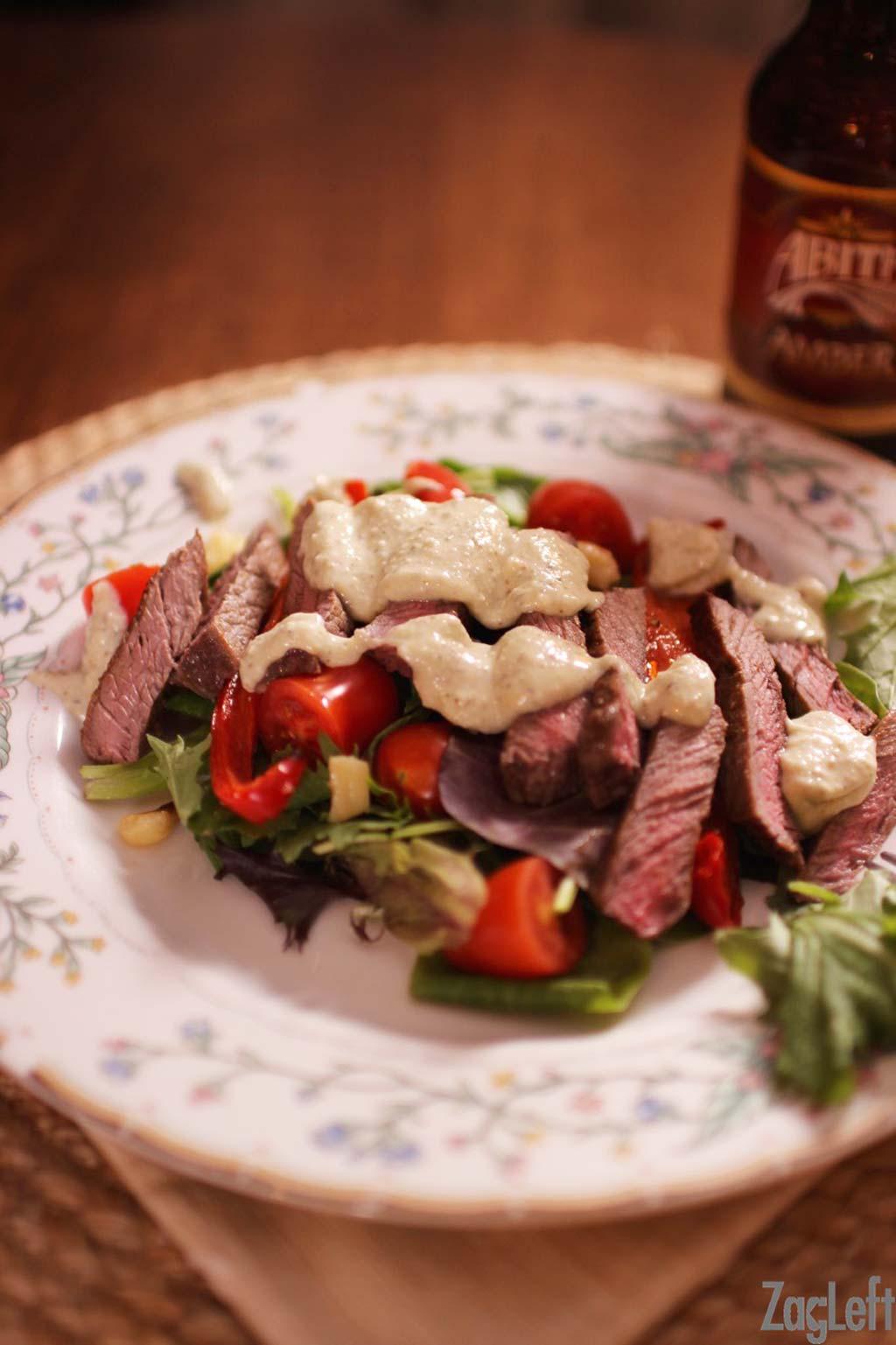 SIZZLING STEAK SALAD 2 garlic cloves 1 medium red pepper, sliced ½ tablespoon olive oil ¼ teaspoon creole seasoning mix (I use Tony Chachere's) 1 Top Sirloin Steak, ¾-inch thick 2 teaspoons neutral