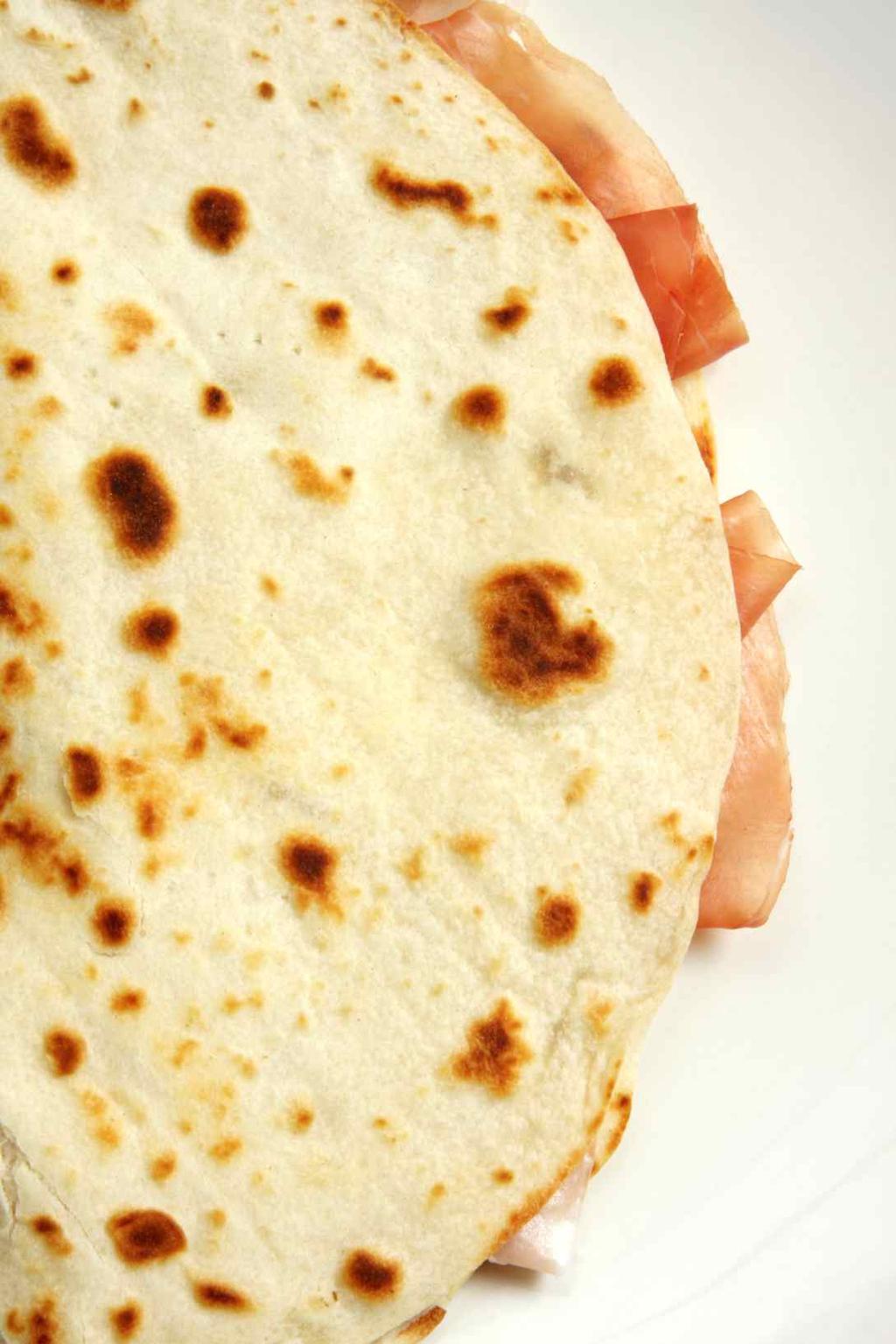 Get every day a different taste History of Piadina Piadina is a very ancient kind of bread. Well-known since ancient Roman time, it was a simple food coming from culinary tradition of poor people.