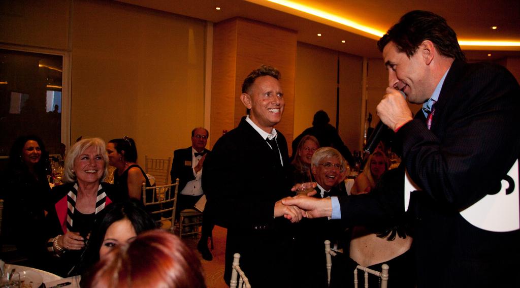 2012 Santa Barbara Wine Auction Master of Ceremonies William Baldwin greets Martin Gore of Depeche Mode.